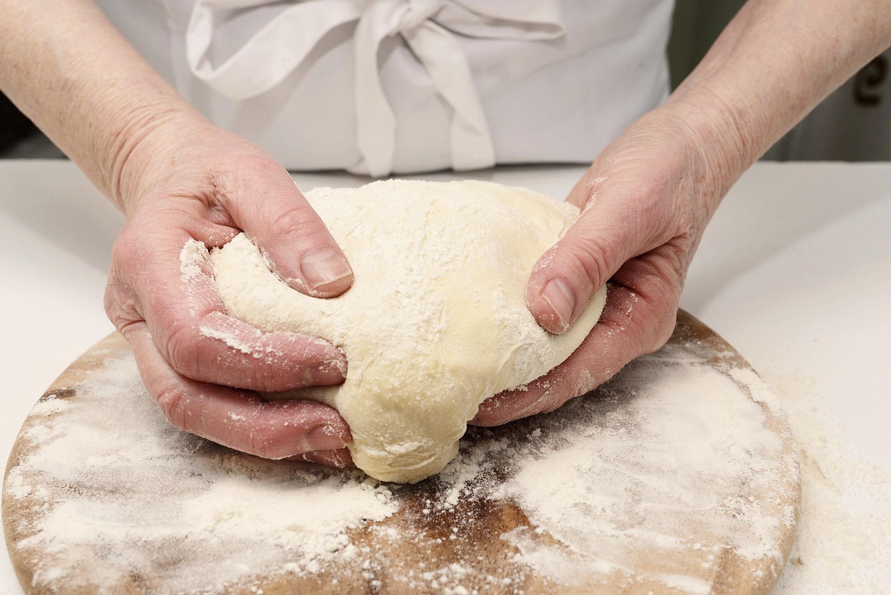 baker shaping sourdough loaf